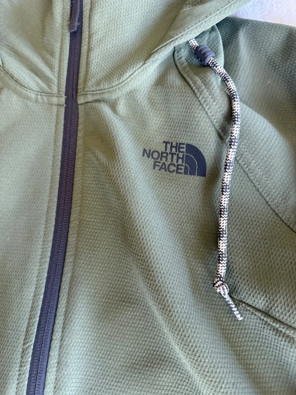 olive green The North Face Tekno Ridge Hoodie features a kangaroo pocket